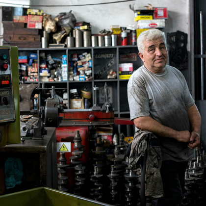 An older man working in a machine shop