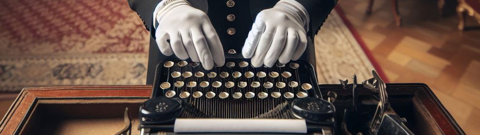 A butler typing on a typewriter