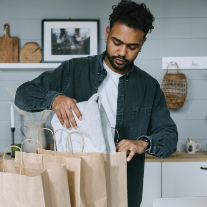 Man packing merchandise in a shop bag