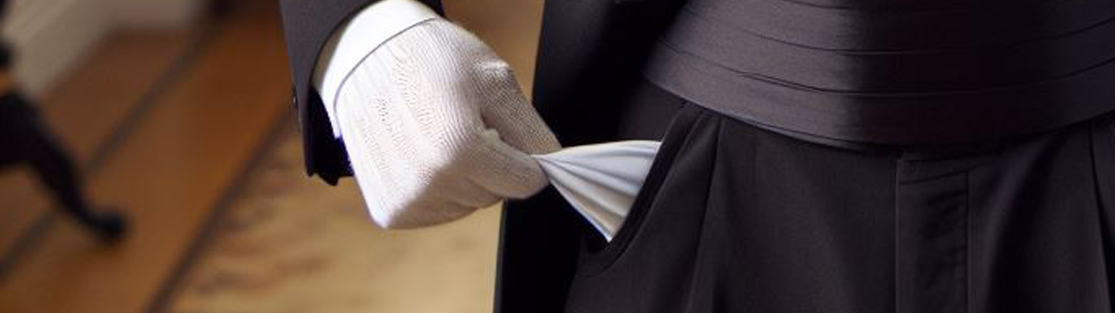 A butler showing his pants pocket is empty