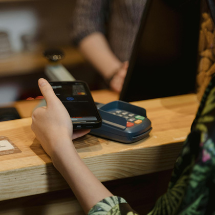 A woman paying for a purchase with her phone